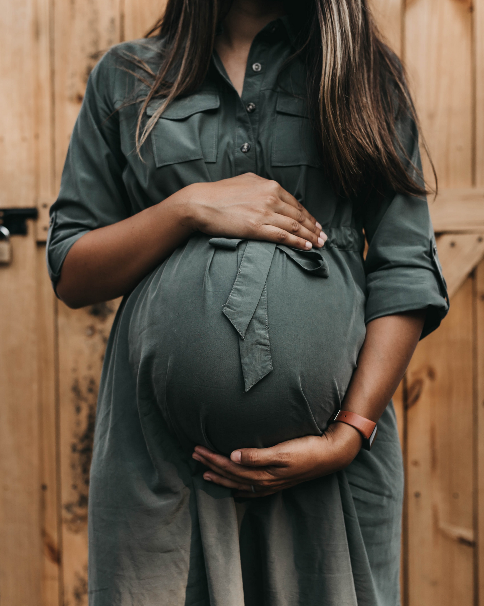 Improve female fertility: woman cradling baby bump