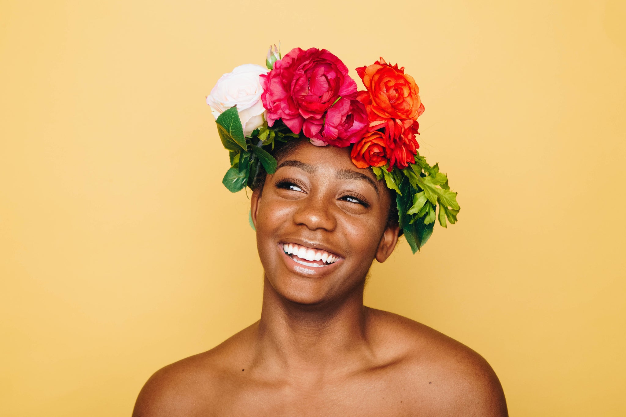 Ways to take care of your mental health when you have PCOS: person smiling wearing flower headpiece