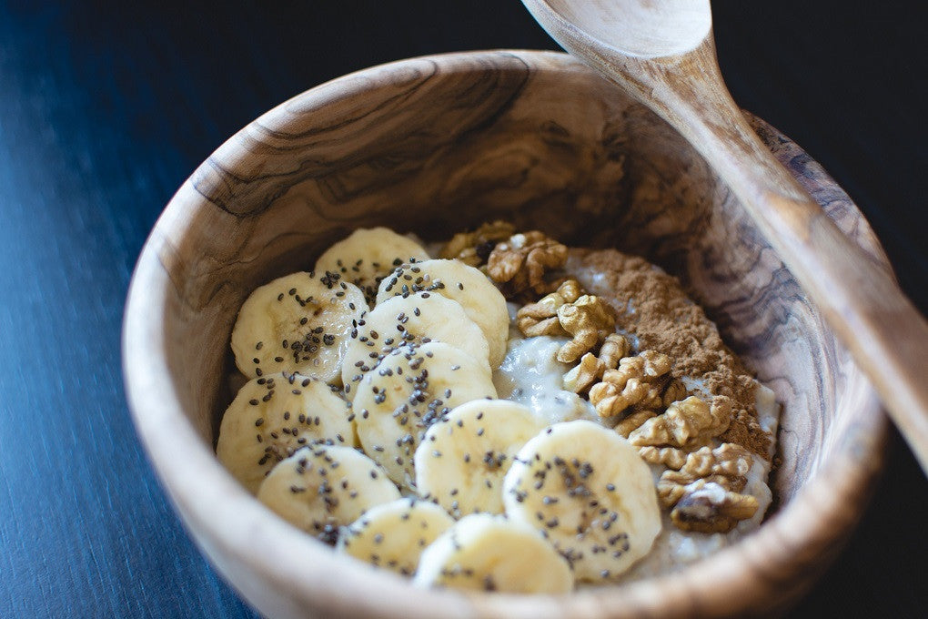 Wheat free oats in a bowl with cinnamon, bananas, walnuts & chai seeds