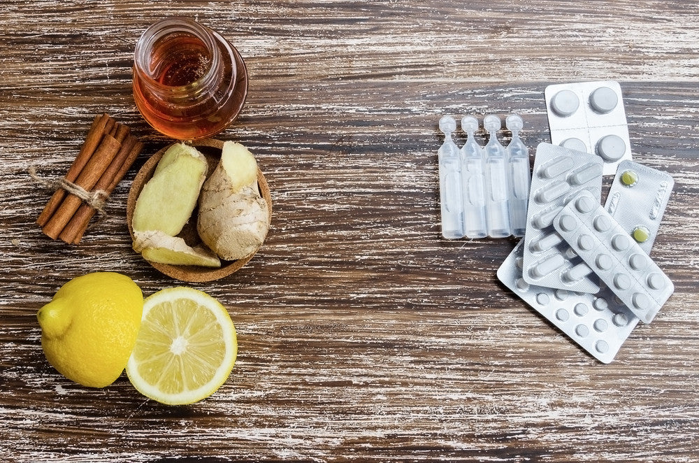 tablets next to lemon, ginger & cinnamon on a table